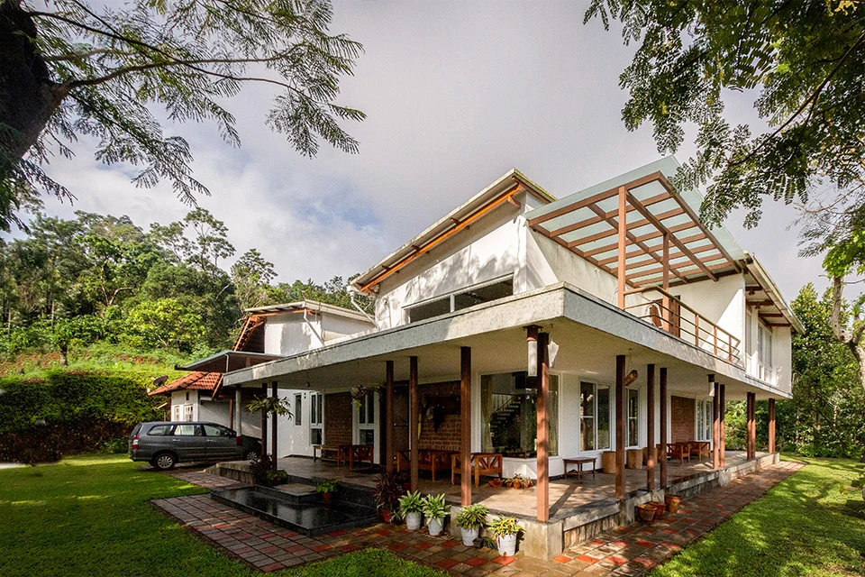 The home in its hillside setting — Malenadu Mane
